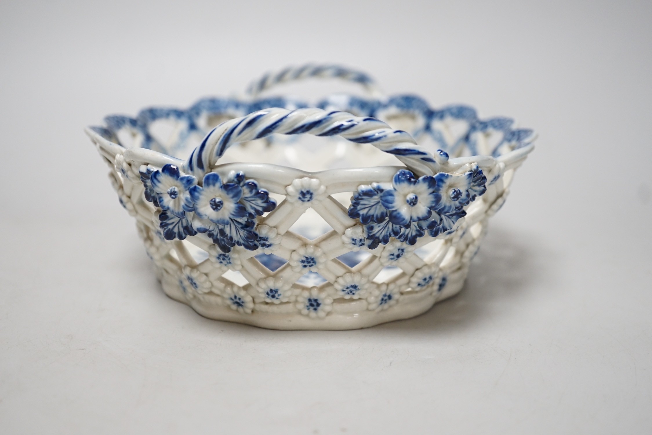 An 18th century Caughley basket printed with fir cones, under a painted border, C mark and very rare IT moulded mark, verso, Ex-Godden Reference Collection, 22cms wide